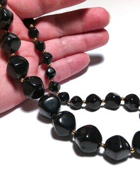 Vintage 1960s Avon necklace featuring a single strand of glossy black plastic